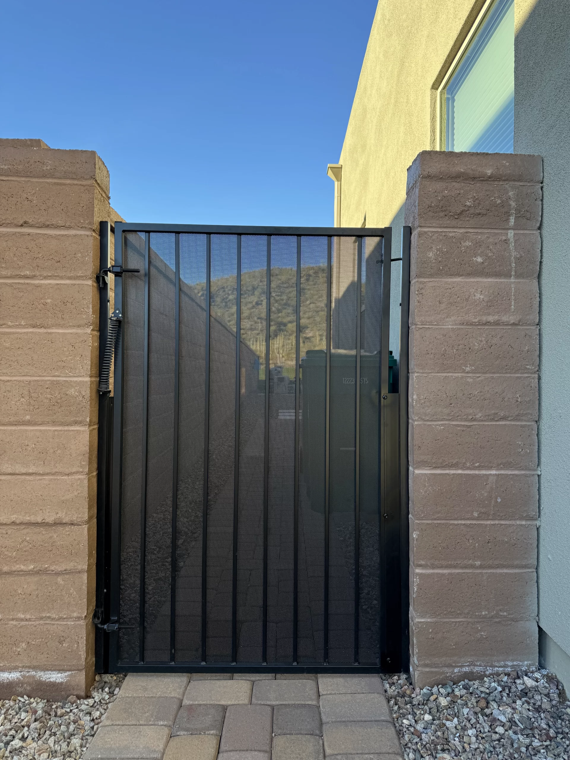 Black mesh fitted to an existing metal residential gate