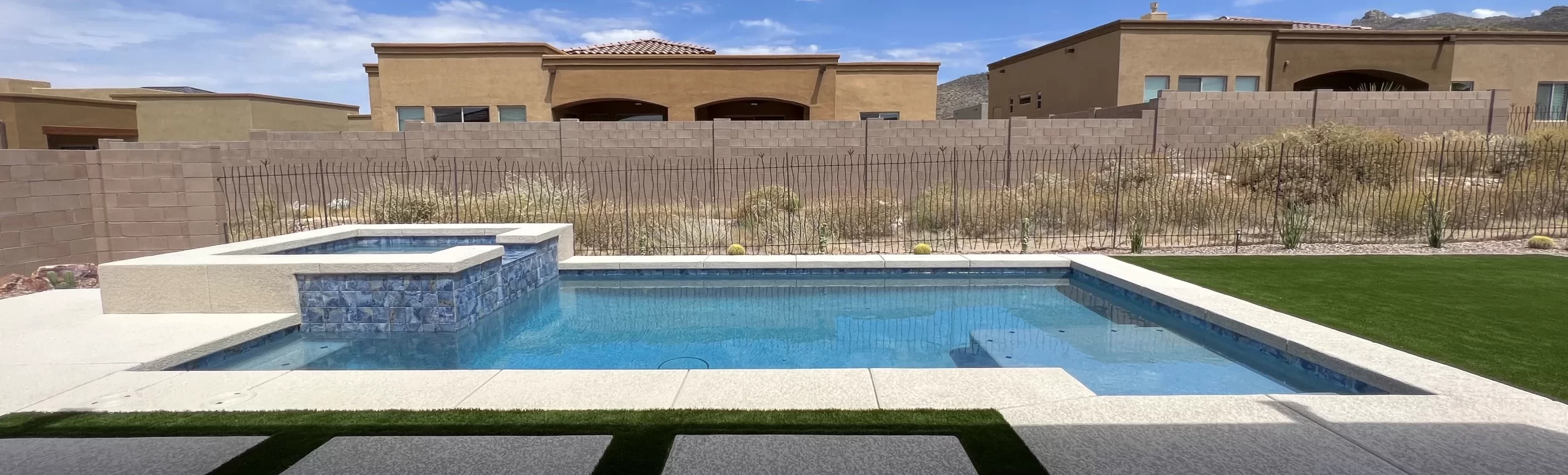 Long black mesh barrier run beside a residential pool and block wall