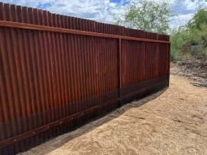 Snake fence attached to metal corrugated fence in Tucson, AZ.