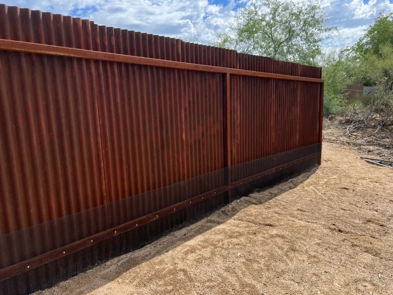 Snake fence attached to metal corrugated fence in Tucson, AZ.