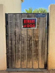 Safe backyard protected by a sturdy snake fence gate from rattlesnakes.